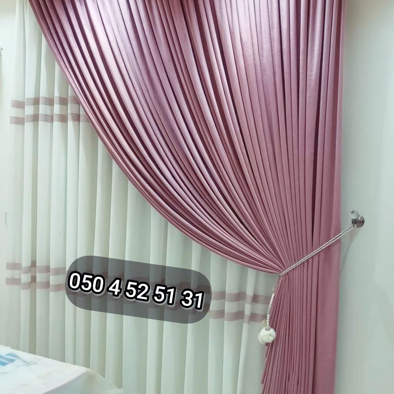 Rose pleated curtains with tieback over striped sheers