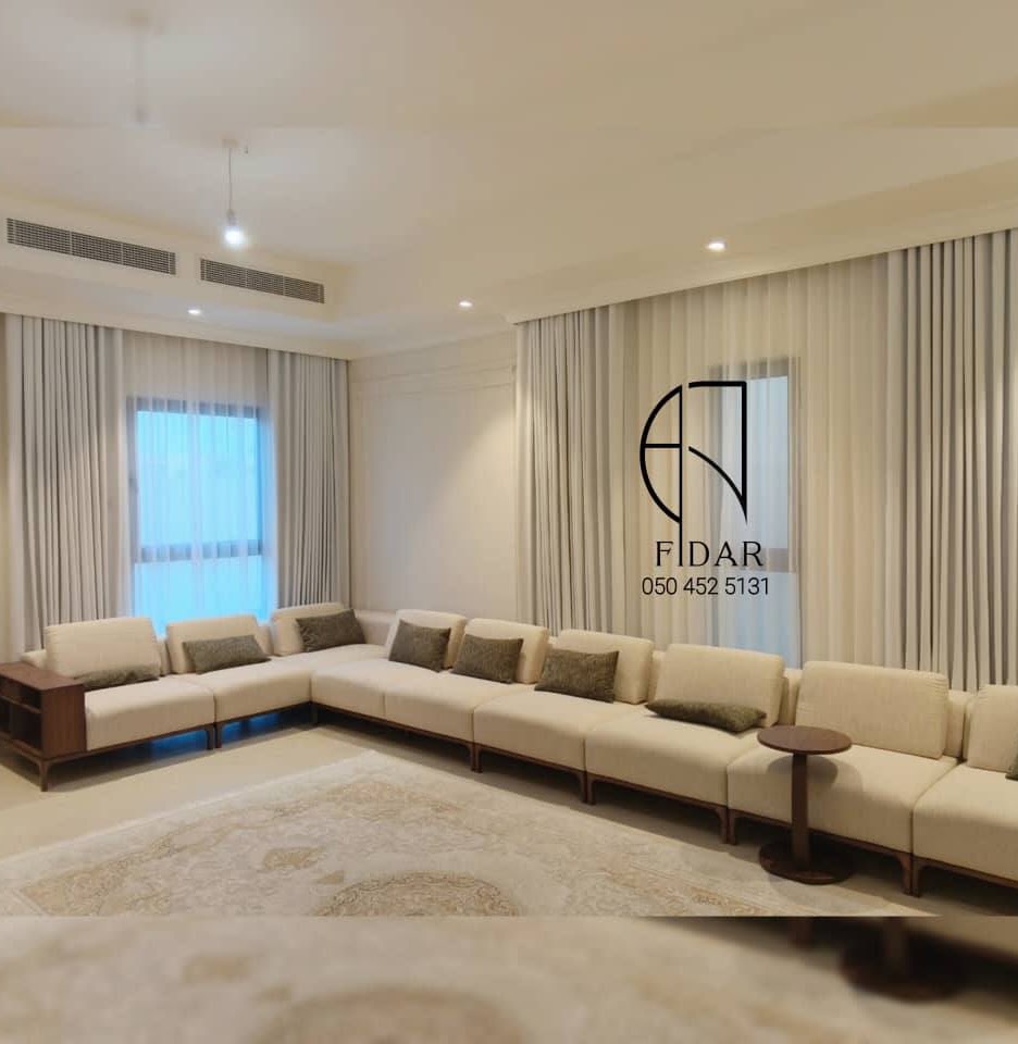 Floor-to-ceiling sheer and blackout curtains in a villa living room